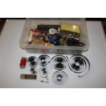 A box containing various clock parts and springs,