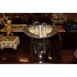 A silver plated wine cooler in the form of a top h