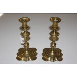 A pair of 18th Century brass candlesticks, 21cm h