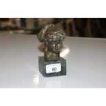 A bronzed bust ion the form of a boy raised on fau