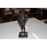 A bronze figure of Shakespeare raised on wooden pl