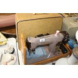 An electric Singer sewing machine with fitted case