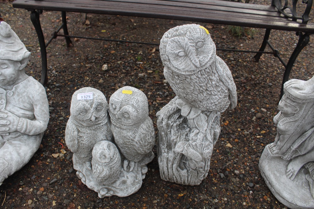 Two concrete garden ornaments in the form of owls