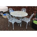 A blue painted metal garden table and a set of fou