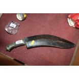 A Kukri knife with leather scabbard