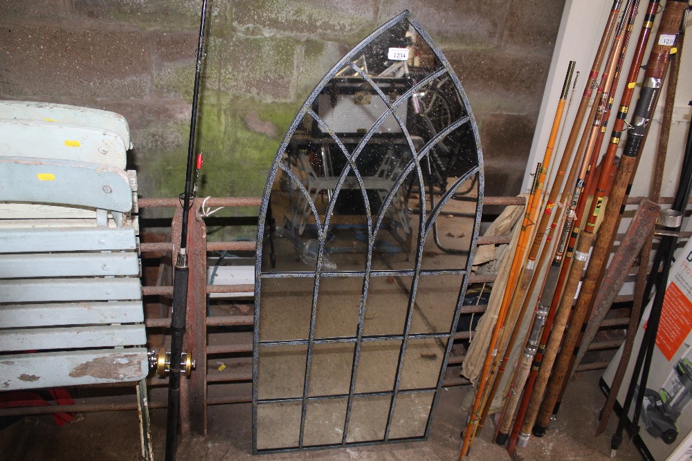 An arched outdoor garden mirror