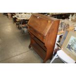 An oak bureau fitted single frieze drawer