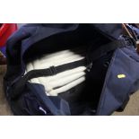 A cricket bag with contents of pads and a helmet