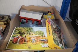 A box containing various games, puzzles, and Thoma