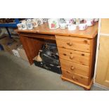 A modern pine kneehole desk fitted four drawers