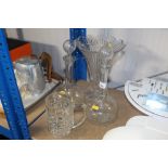A cut glass vase, a pair of decanters and stoppers