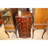 A reproduction mahogany cupboard with mock drawer