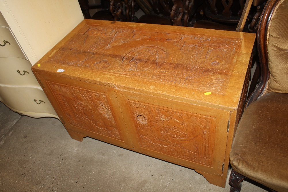 An carved Oriental low chest of three drawers encl