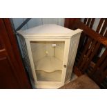 A cream painted hanging corner display cabinet