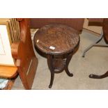 A small Eastern carved two tier occasional table r