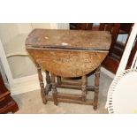An antique gate leg tea table