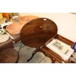 An oak circular topped tripod occasional table