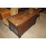 An antique oak and inlaid three panel coffer