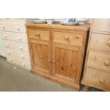 A modern stripped pine side cupboard fitted two dr