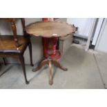 A mahogany circular table raised on turned column an