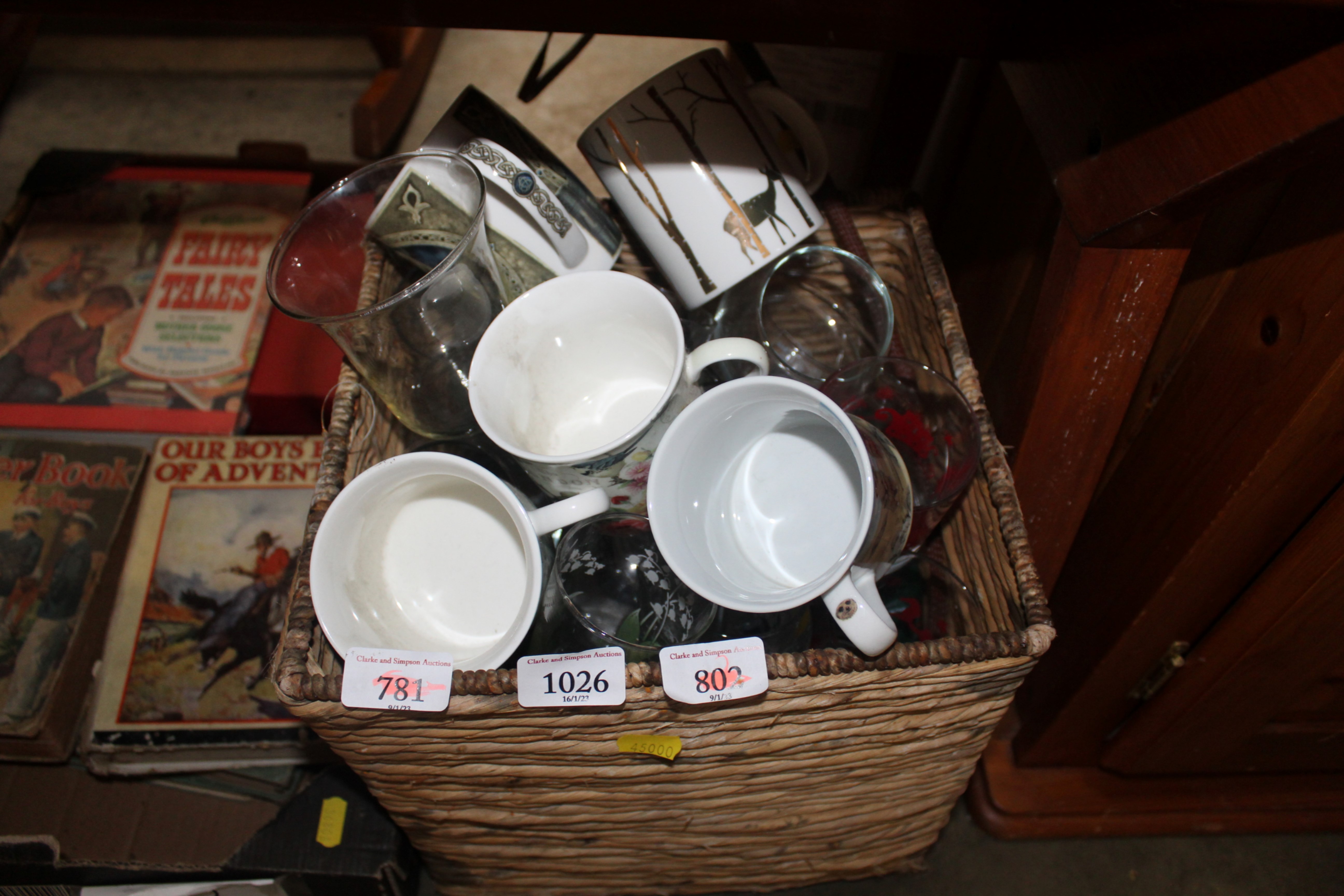 A wicker basket with contents of glass and china