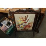 An oak embroidered fire screen