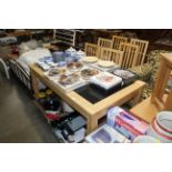 A modern light wood dining table and set of six ch