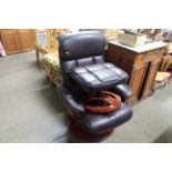 A leatherette upholstered swivel chair and foot st