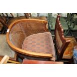 A wooden framed and cane backed upholstered tub ch