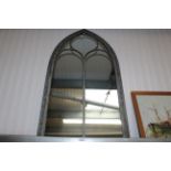 An arch framed wall mirror