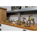 A collection of various brass ornaments and hand b