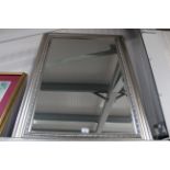 A silvered frame mirror with bevelled edge