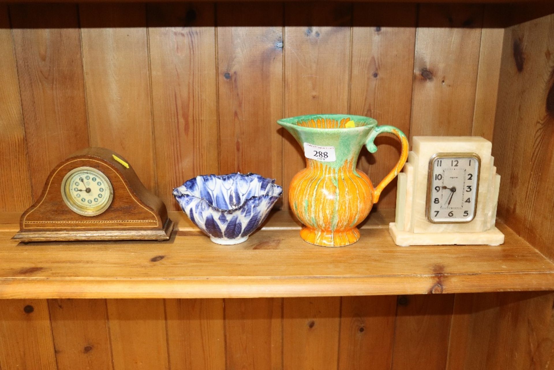 An Art Deco mantel clock; a Roskyl Pottery jug; an