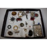 A collection of Miracle brooches including ASP and