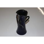 A blue glazed Watcombe Pottery three handled vase