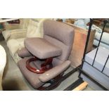 A Stressless reclining armchair and foot stool