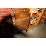 An oak bureau fitted three drawers