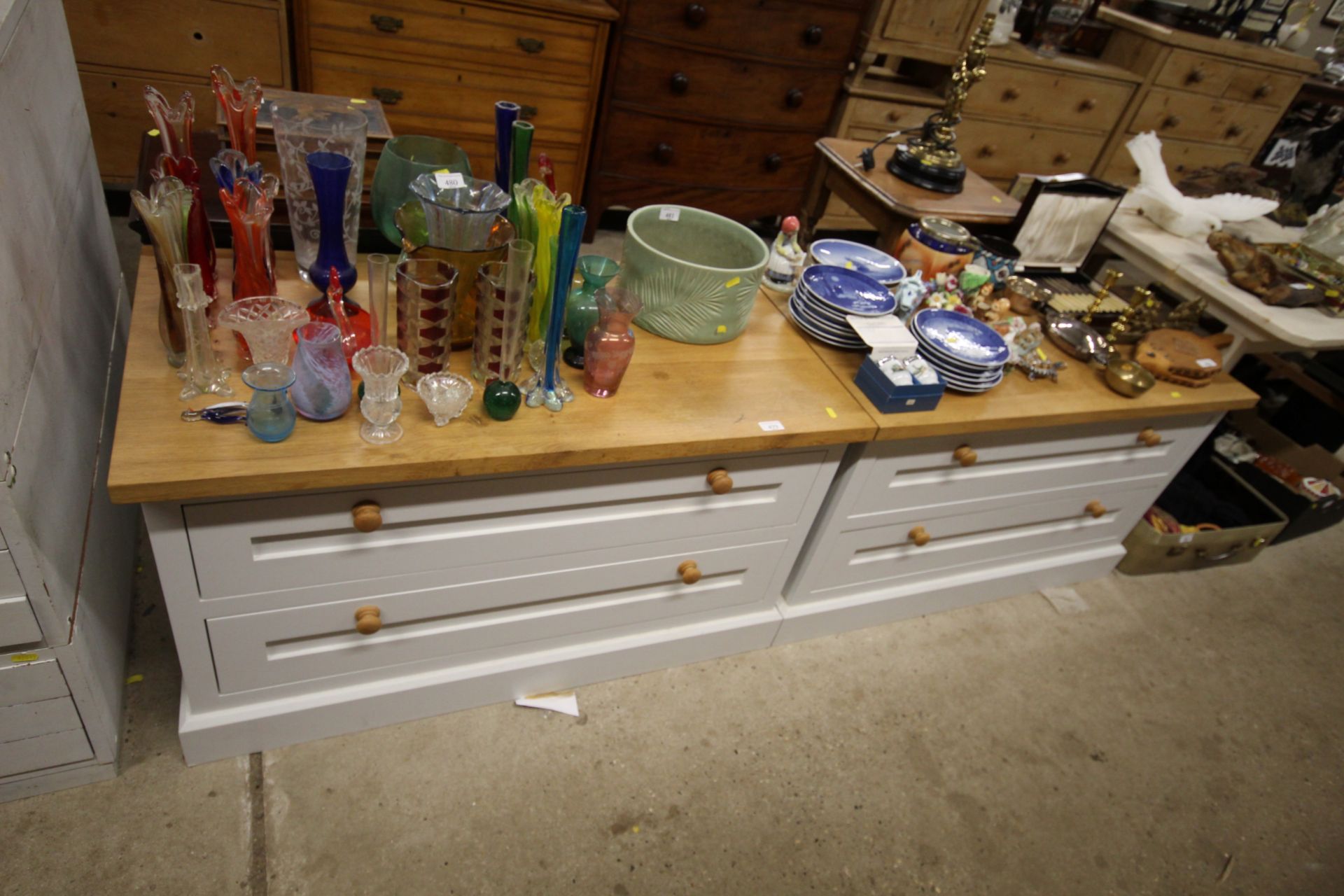 A pair of oak topped two drawer chests