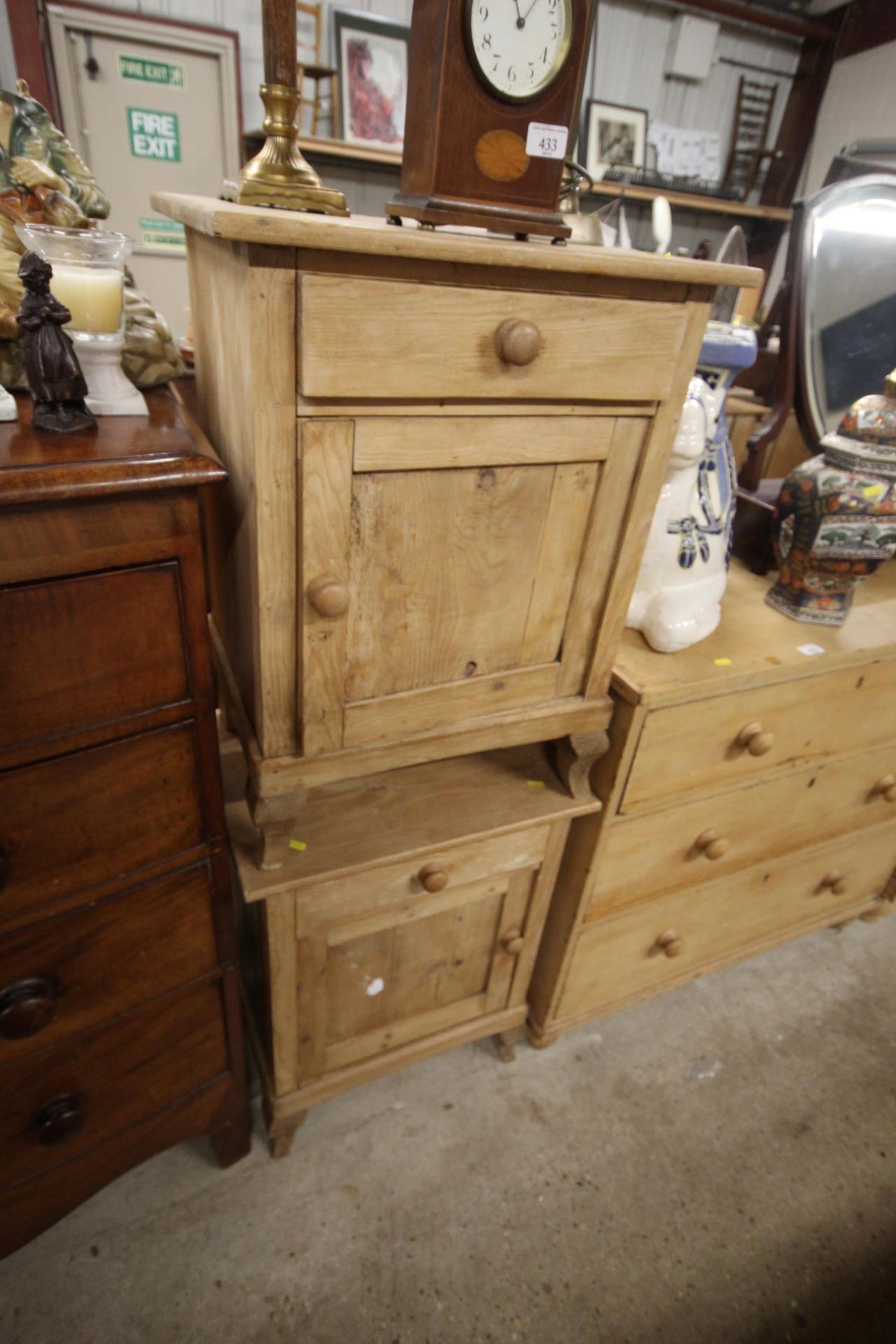 A pair of stripped pine bedside cupboards