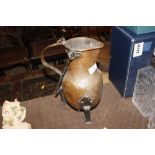 An antique copper and wrought iron jug with swing