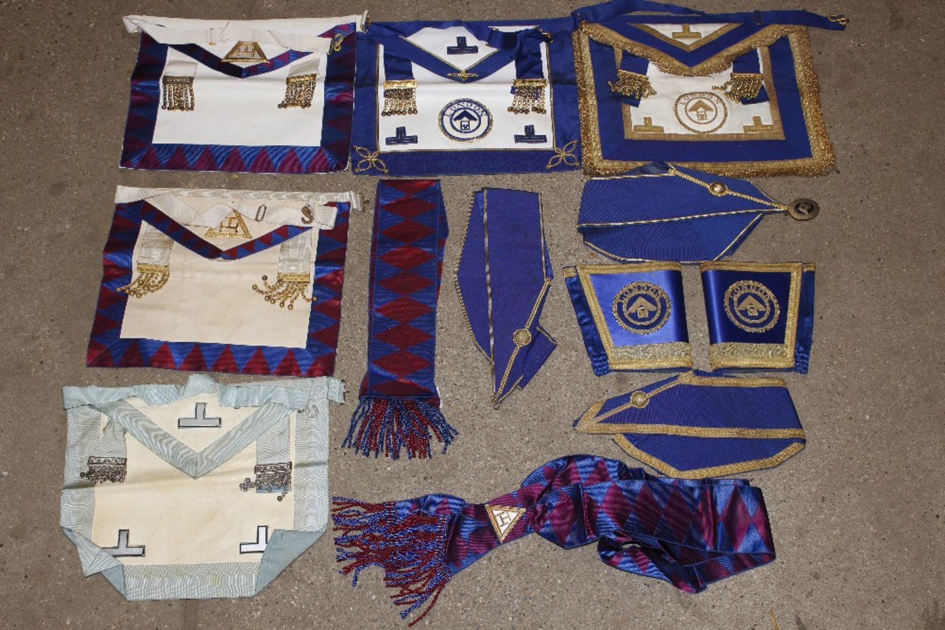 A case of Masonic aprons and regalia, including si