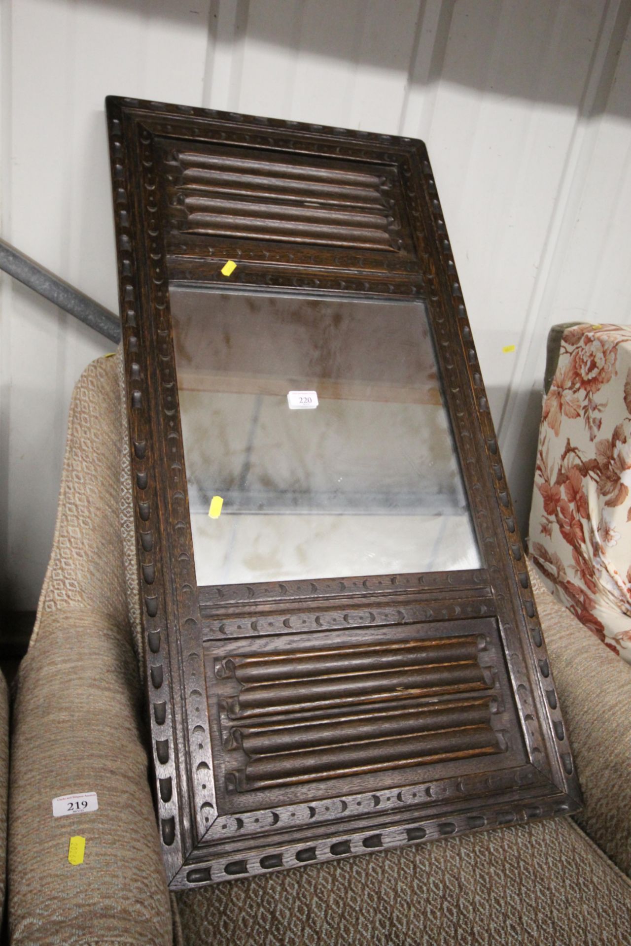 An oak linen fold decorated mirror