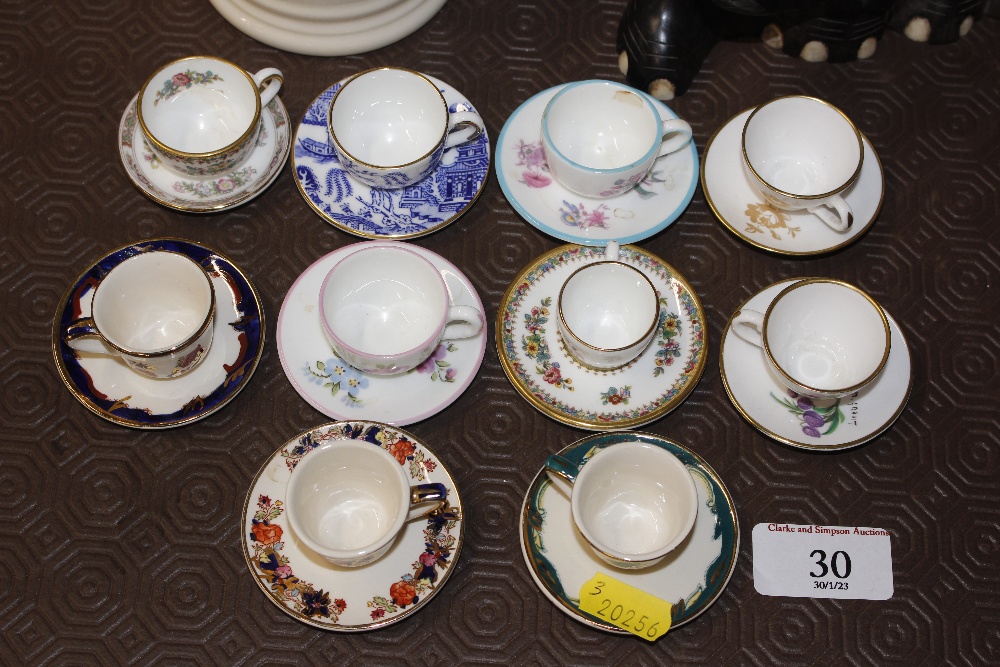 A quantity of miniature cups and saucers to includ