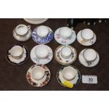 A quantity of miniature cups and saucers to includ