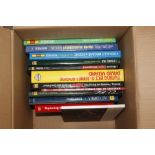 A box of various car related books with vendors at