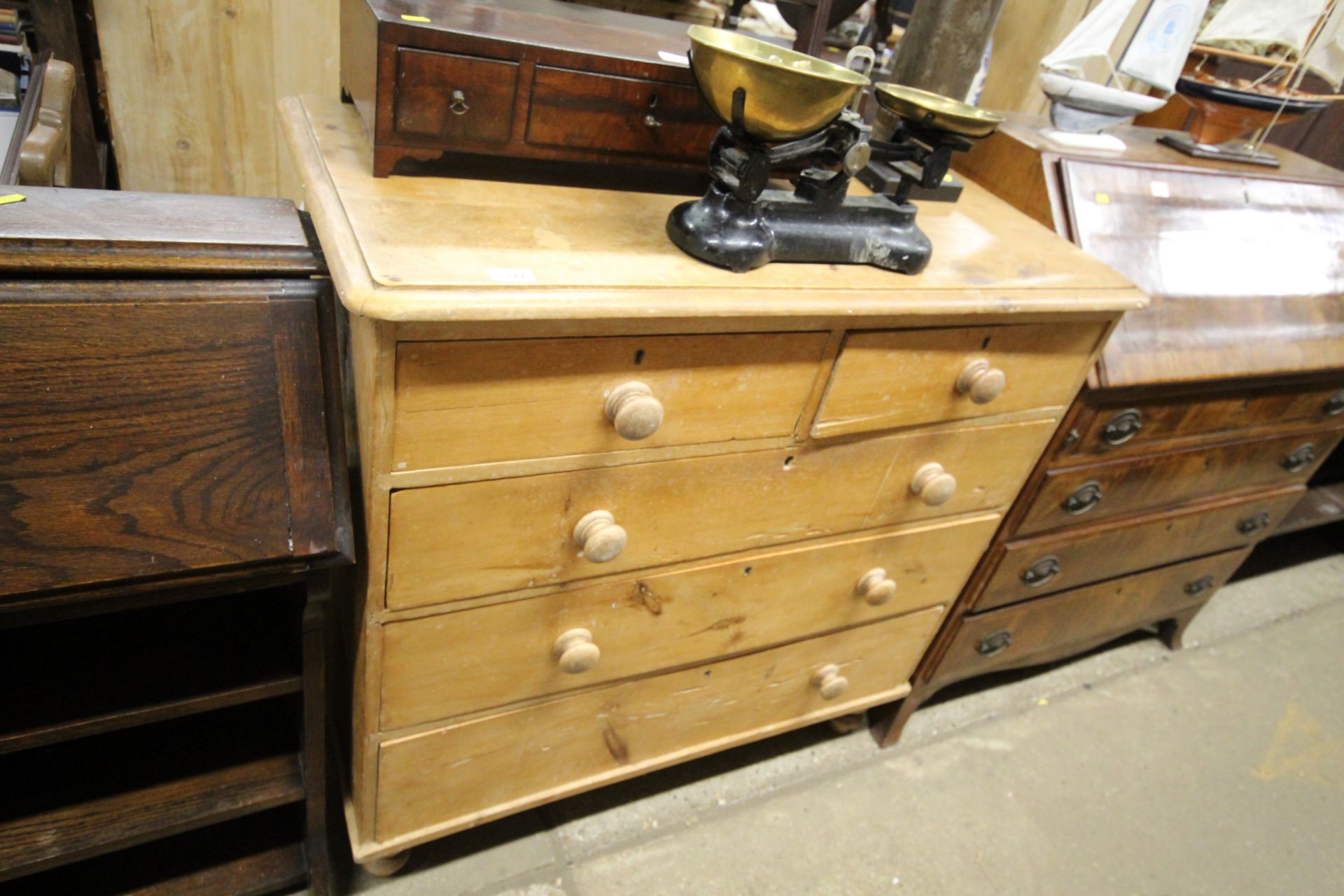 An antique stripped pine chest fitted two short ov