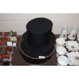 A collapsible top hat in fitted box