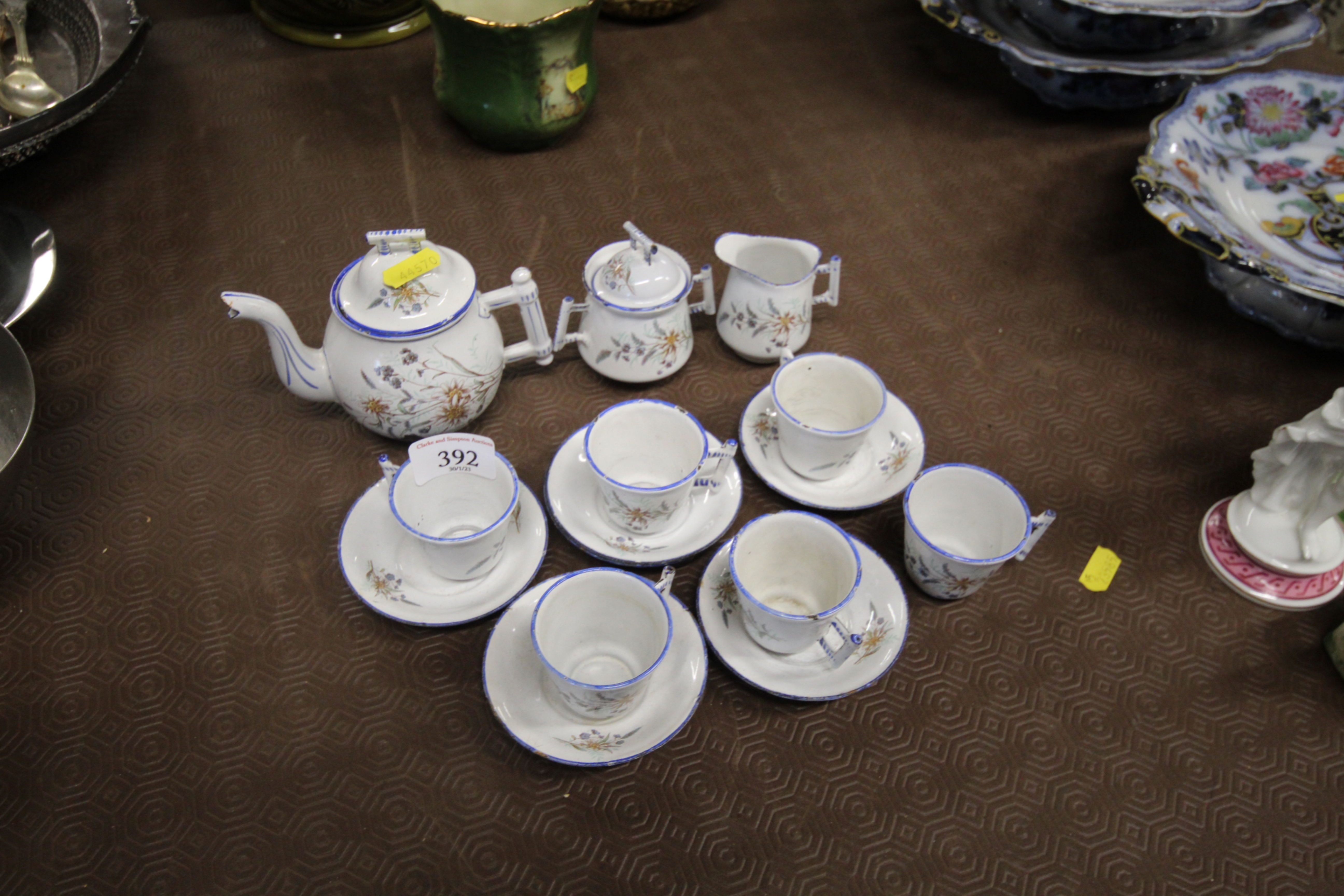 A quantity of enamel floral decorated dolls tea wa