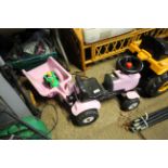 A small pink child's tractor and trailer together with a small toy tractor