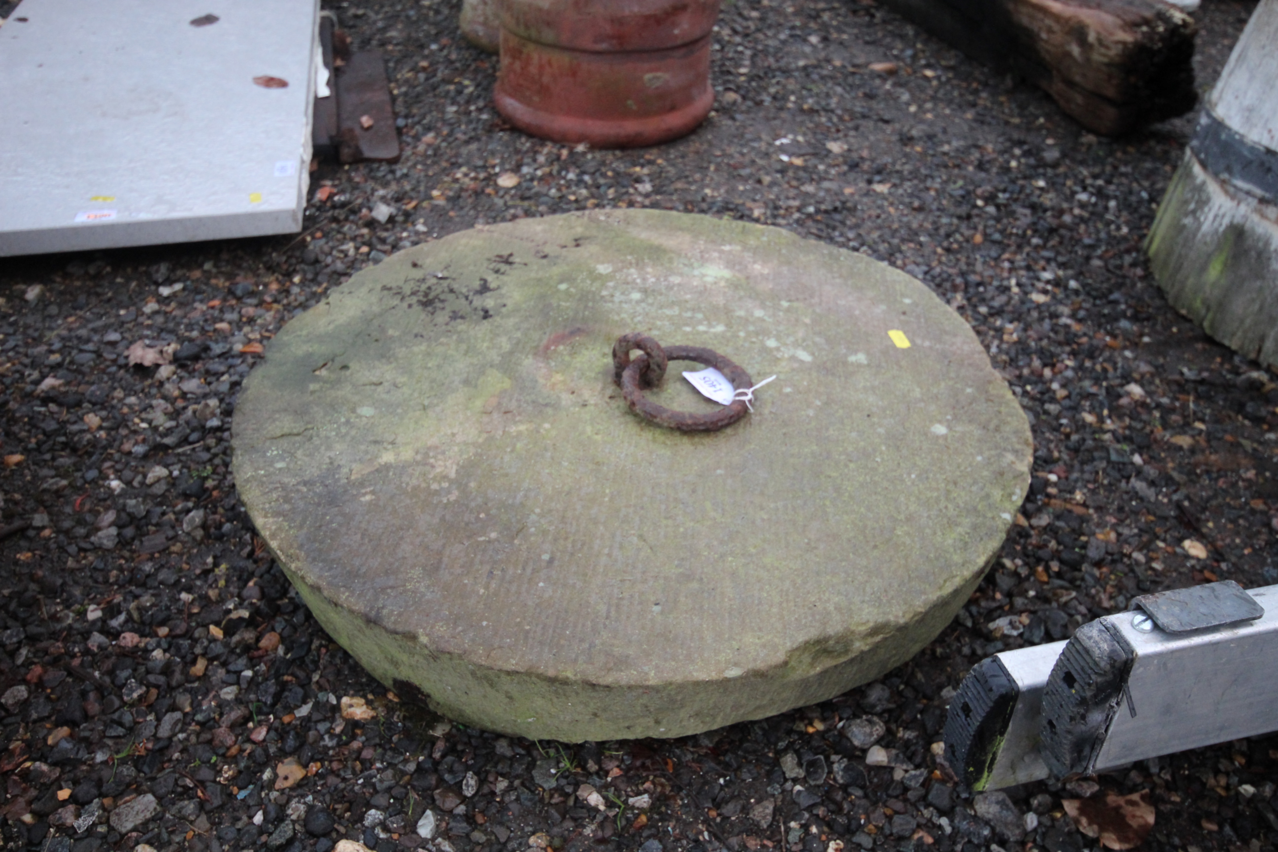 A concrete base with iron securing ring to centre